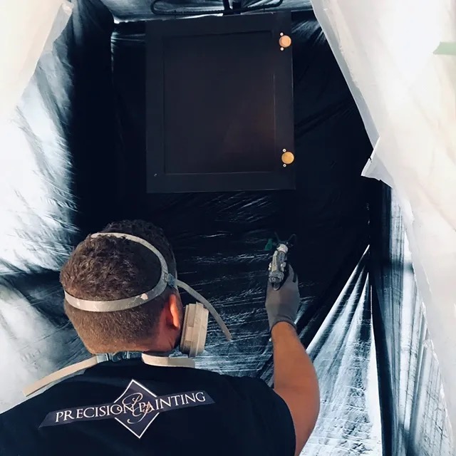 Precision Painting crew completing cabinet refinishing work